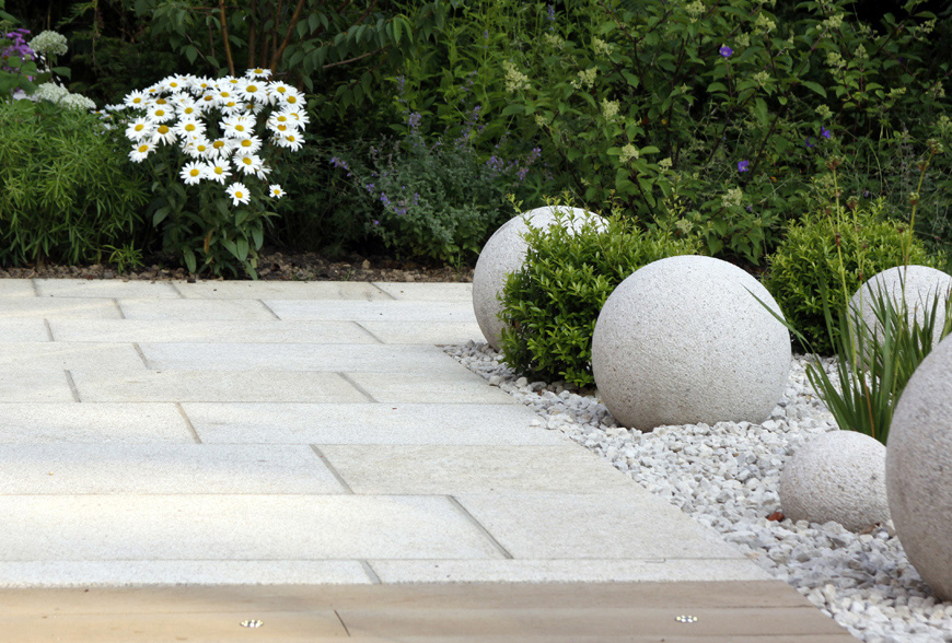 sculptural granite balls add interest in this greencube garden design in crouch, kent
