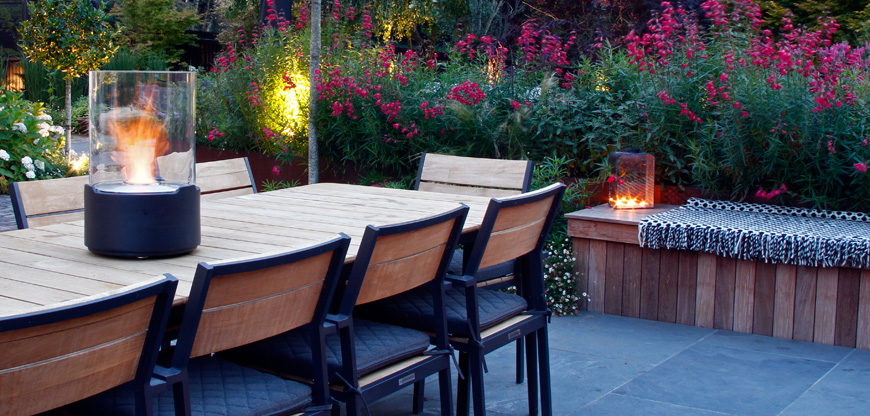 Outdoor dining into the evening warmed by a tabletop firebowl