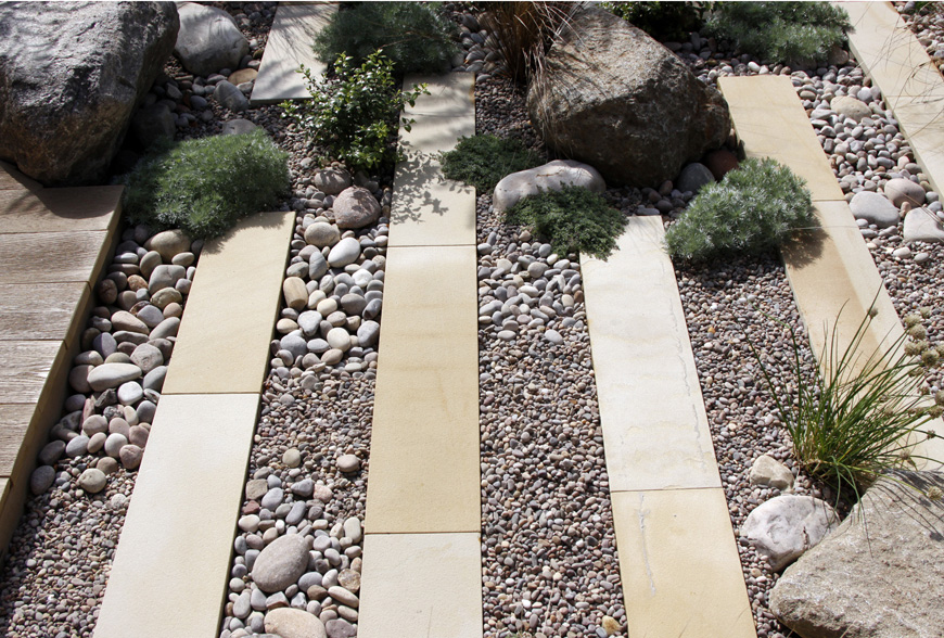 pebbles, boulders combined with sawn plank paving deliver contrasts in chislehurst, kent by greencube